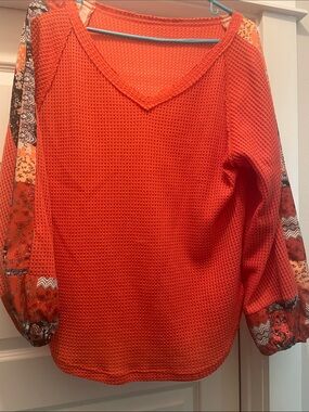 Women's Orange Waffle Knit V-Neck Blouse with Patterned Sleeve Panels